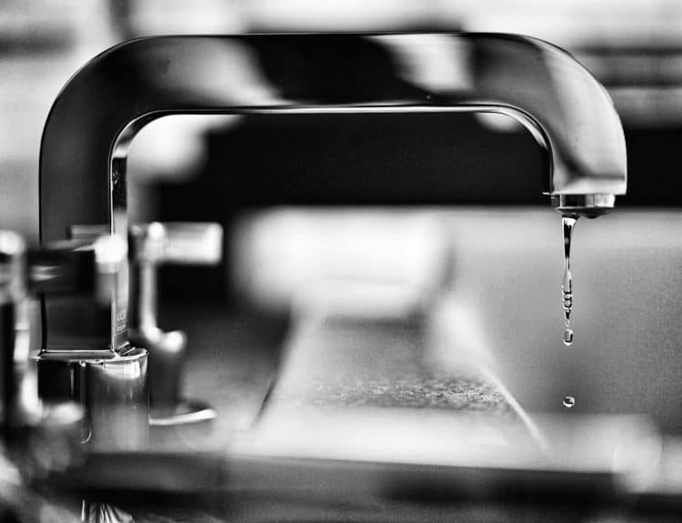 grayscale photography of faucet